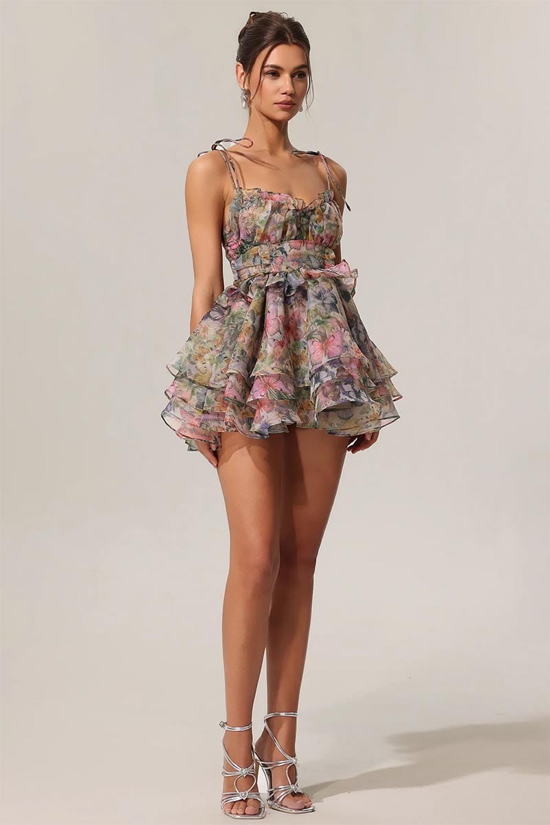 Woman wearing a floral dress against a plain background | Evelina Floral Print Mini Dress | Jewelclues